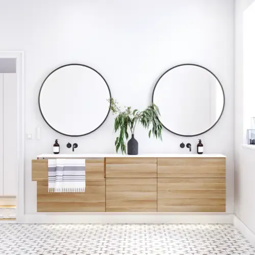 Nordic bathroom in wood finish with beautiful black framed round mirrors and plenty of storage in the furniture