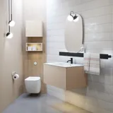 Stylish bathroom inspiration with beige vanity unit with inner drawer, upper cabinet, open shelf, oval mirror with lighting, matching pendants, shelf under the mirror, and wall-mounted toilet. Walls with light, elongated tiles