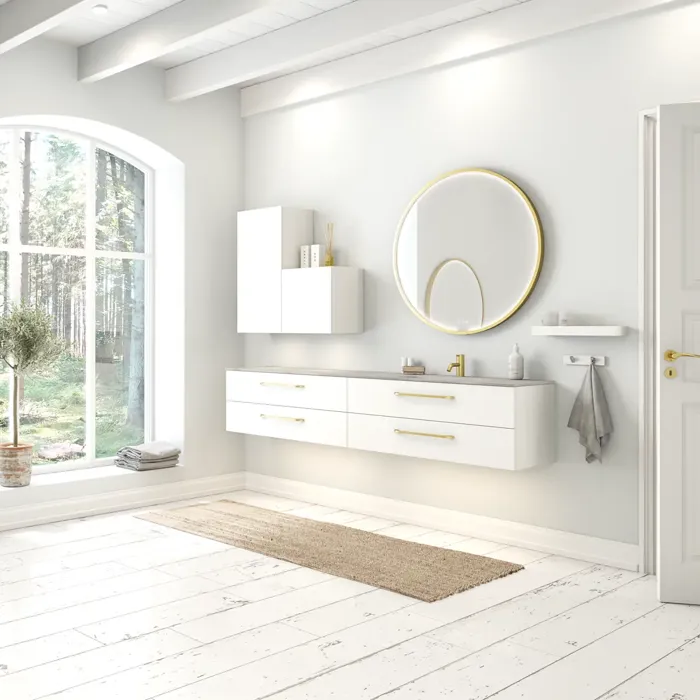 Large and romantic bathroom with brass framed round mirror