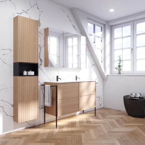 Bathroom inspiration with washbasin cabinets and wall cabinets in light oak with grooves, elegant double sink, beautiful mirror cabinet with light, herringbone floor in light wood, and white marble wall give a classic, bright, and sleek look.