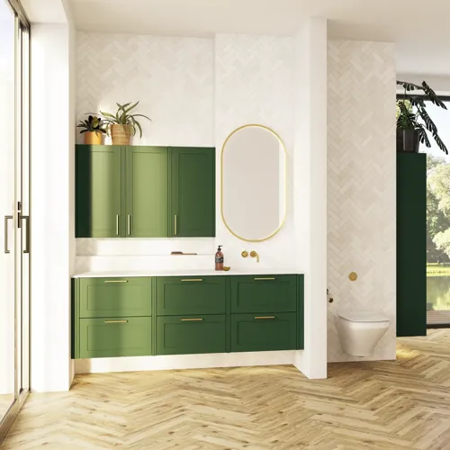 Large bathroom in green colors with vanity unit, brass framed oval mirror and beautiful framed doors
